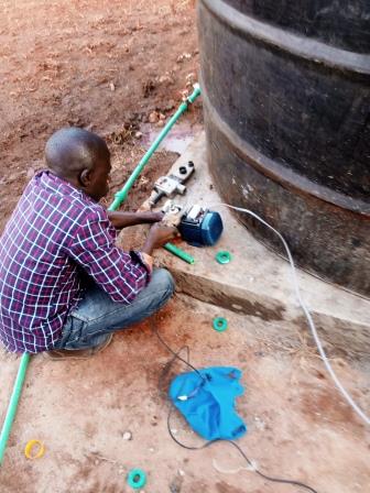 A plumber fixing a water pump