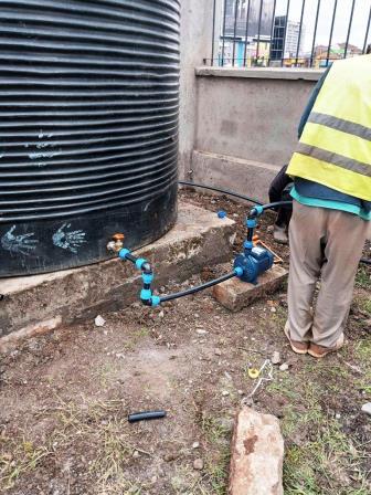 A plumber setting up an irrigation system for the home